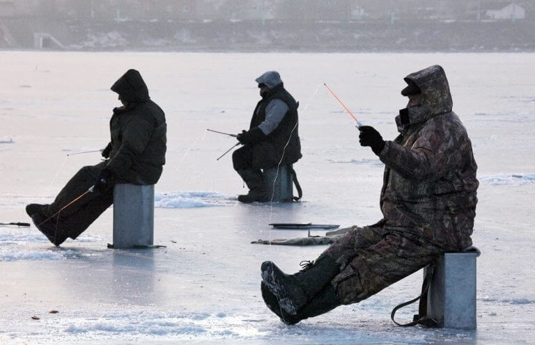 Fishermen on ice, catching pike